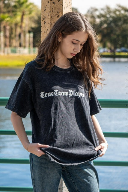 Model wearing the black washed lightweight t-shirt by the water